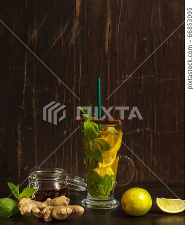 Refreshing drink that is good for digestion with lemon, ginger and mint on a dark background Refreshing drink that is good for digestion with lemon, ginger and mint on a dark background 66853095