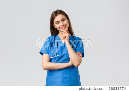 Medical workers, healthcare, covid-19 and vaccination concept. Upbeat smiling pretty nurse, doctor in blue scrubs, working clinic, looking with enthusiastic gaze camera, listening to coworker Medical workers, healthcare, covid-19 and vaccination concept. Upbeat smiling pretty nurse, doctor in blue scrubs, working clinic, looking with enthusiastic gaze camera, listening to coworker 66853774