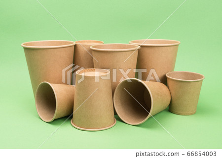 Paper cups on a green background. Close-up. Paper cups on a green background. Close-up. 66854003