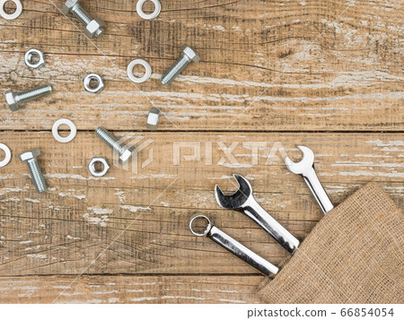 Wrenches, bolts and nuts on wooden background. Wrenches, bolts and nuts on wooden background. 66854054