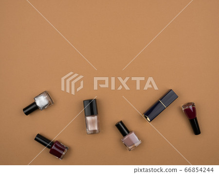 The nail polishes and lipstick . Beige background. 66854244