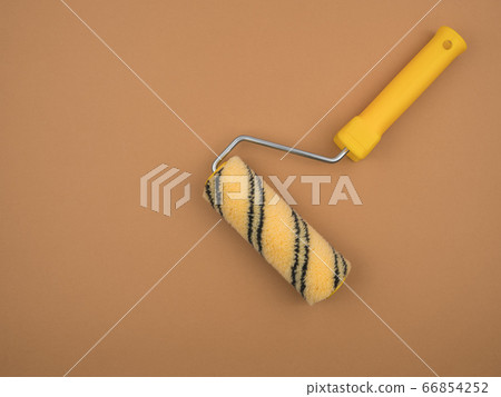 Paint roller on beige background. Construction tool. Paint roller on beige background. Construction tool. 66854252
