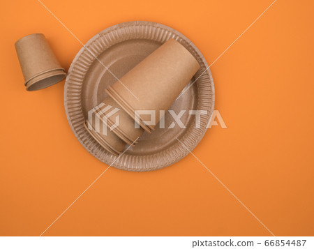 Cardboard utensils for the kitchen and picnic on an orange background. 66854487