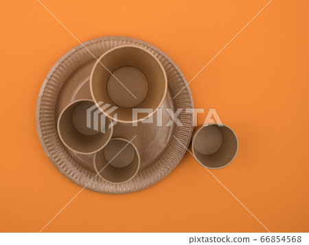Environmental utensils on an orange background. The view from the top. 66854568