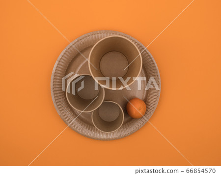 Organic dishes and fruit on an orange background. 66854570