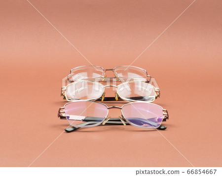 Glasses - an accessory for better vision on a brown background. 66854667
