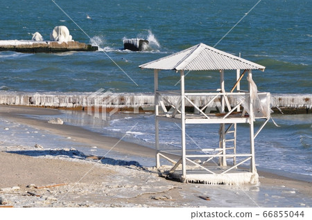 Abandoned Rescue Station. Beach tower on the Black Sea in winter Abandoned Rescue Station. Beach tower on the Black Sea in winter 66855044