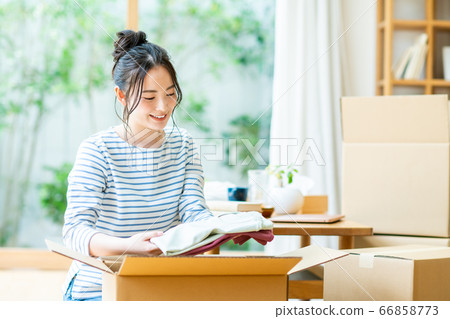 Young woman preparing to move Young woman preparing to move 66858773