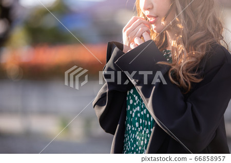 A beautiful woman standing outside is a cold winter A beautiful woman standing outside is a cold winter 66858957