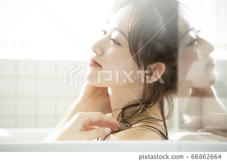 A young lady bathing 66862664