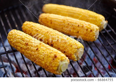 close up of corn roasting on grill close up of corn roasting on grill 66864755