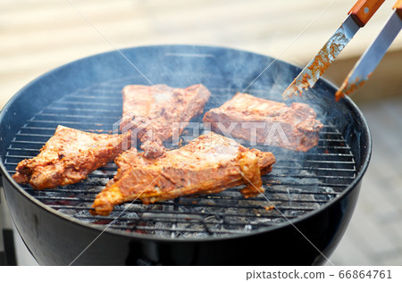 close up of barbecue meat roasting on grill close up of barbecue meat roasting on grill 66864761