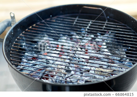charcoal smoldering in brazier outdoors 66864815