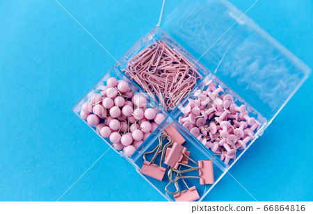 pins and clips in plastic pox on blue background pins and clips in plastic pox on blue background 66864816
