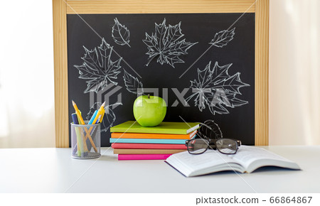 books, apple and school supplies on table at home books, apple and school supplies on table at home 66864867