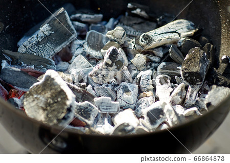 charcoal smoldering in brazier outdoors 66864878