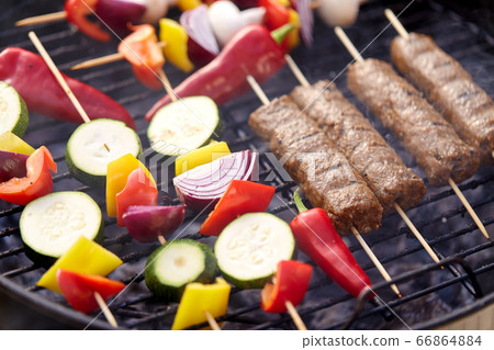 close up of barbecue kebab meat roasting on grill close up of barbecue kebab meat roasting on grill 66864884