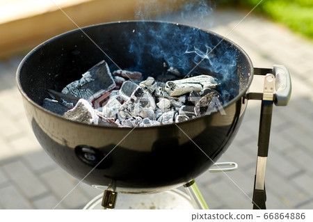 charcoal smoldering in brazier outdoors charcoal smoldering in brazier outdoors 66864886