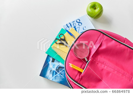 backpack with books, school supplies and apple 66864978