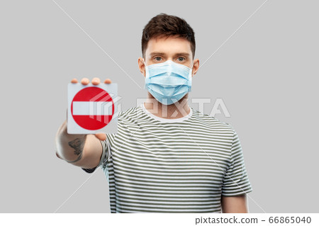 young man girl in medical mask showing stop sign 66865040