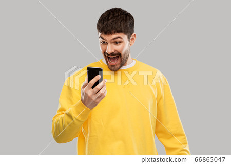 happy smiling young man with smartphone happy smiling young man with smartphone 66865047