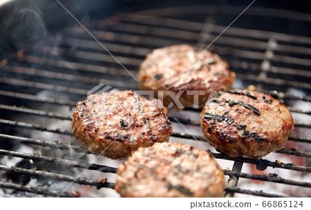 close up of meat cutlets roasting on grill 66865124