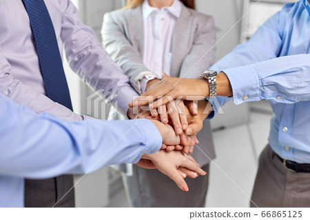 close up of business team stacking hands at office close up of business team stacking hands at office 66865125