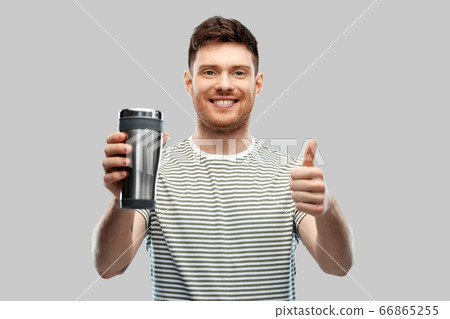 man with thermo cup or tumbler showing thumbs up man with thermo cup or tumbler showing thumbs up 66865255