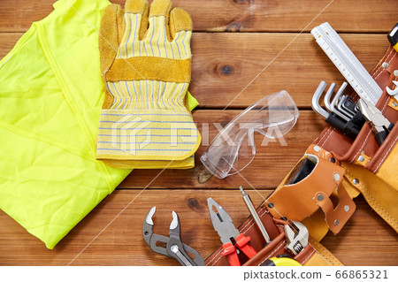 different work tools in belt on wooden boards different work tools in belt on wooden boards 66865321