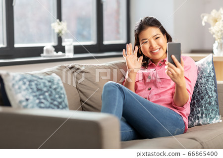 woman with smartphone having video call at home woman with smartphone having video call at home 66865400
