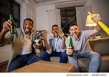friends or soccer fans with ball and beer at home friends or soccer fans with ball and beer at home 66865404