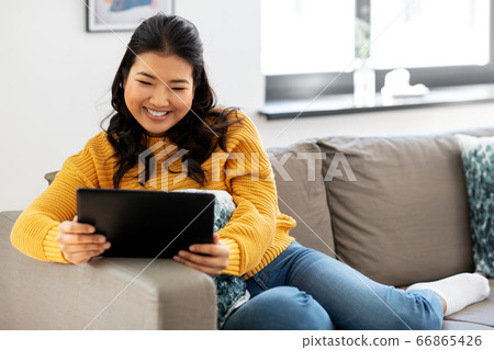 asian young woman with tablet pc computer at home asian young woman with tablet pc computer at home 66865426