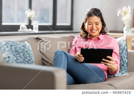 asian young woman with tablet pc computer at home asian young woman with tablet pc computer at home 66865428