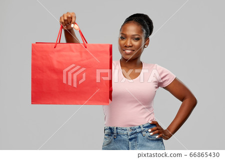 happy african american woman with shopping bag happy african american woman with shopping bag 66865430