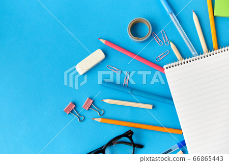 notebook and school supplies on blue background notebook and school supplies on blue background 66865443