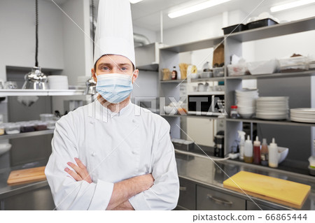male chef cook in face mask at restaurant kitchen 66865444