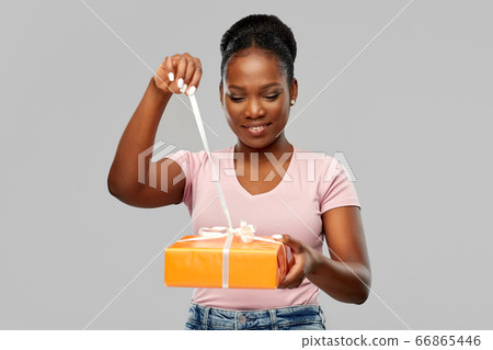 happy african american woman with gift box happy african american woman with gift box 66865446