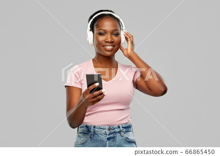 african woman in headphones listening to music 66865450