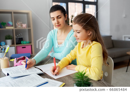 mother and daughter doing homework together 66865484