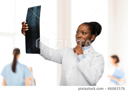 african american female doctor looking at x-ray 66865576