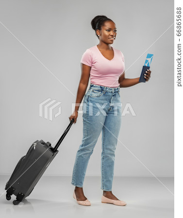 happy young woman with air ticket and travel bag happy young woman with air ticket and travel bag 66865688