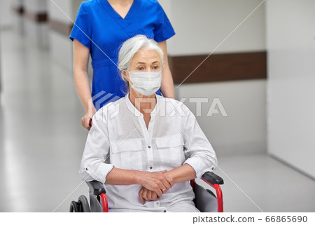 senior woman in mask in wheelchair at hospital senior woman in mask in wheelchair at hospital 66865690