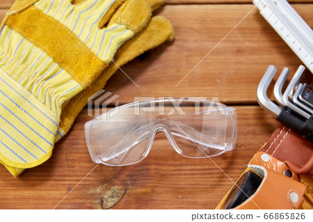 different work tools in belt on wooden boards different work tools in belt on wooden boards 66865826