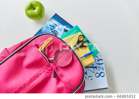 backpack with books, school supplies and apple 66865832