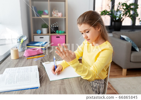 student girl with book writing to notebook at home student girl with book writing to notebook at home 66865845