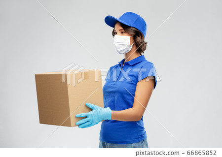 delivery woman in face mask holding parcel box delivery woman in face mask holding parcel box 66865852