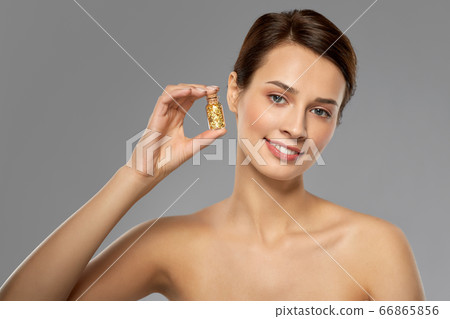 beautiful young woman with gold facial mask 66865856
