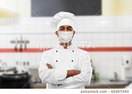 male chef in face mask at restaurant kitchen male chef in face mask at restaurant kitchen 66865940