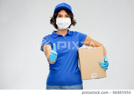 delivery woman in face mask holding parcel box 66865950