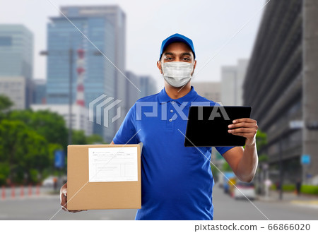 delivery man in mask with tablet pc and parcel box 66866020